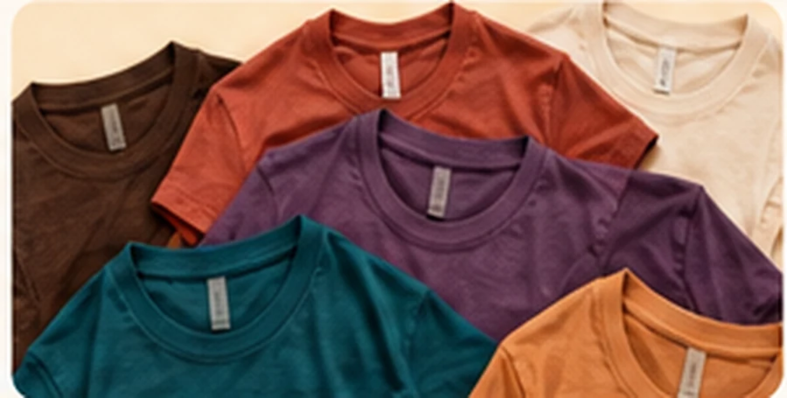Seven earthy and jewel-toned tees arranged together