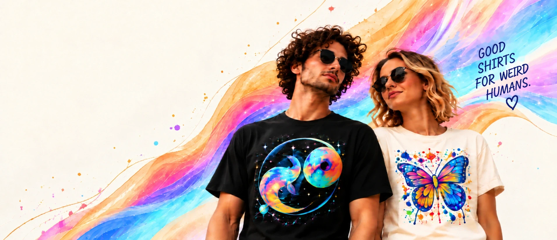 Two models wearing vivid cosmic and butterfly graphic tees amid luminous rainbow ribbons