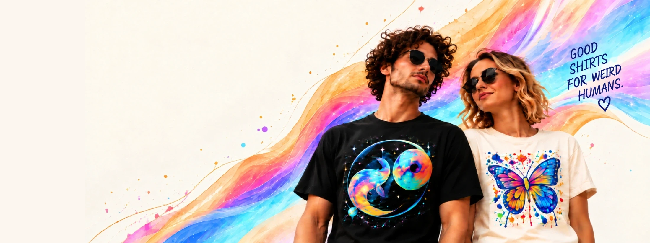 Two models wearing vivid cosmic and butterfly graphic tees amid luminous rainbow ribbons